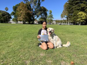 Dog training certification celebration with a girl and her trained Labrador Retriever.